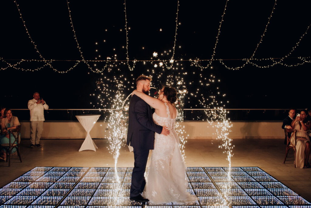 bride and groom first dance at hyatt ziva cancun wit light up dance floor and cold sparklers