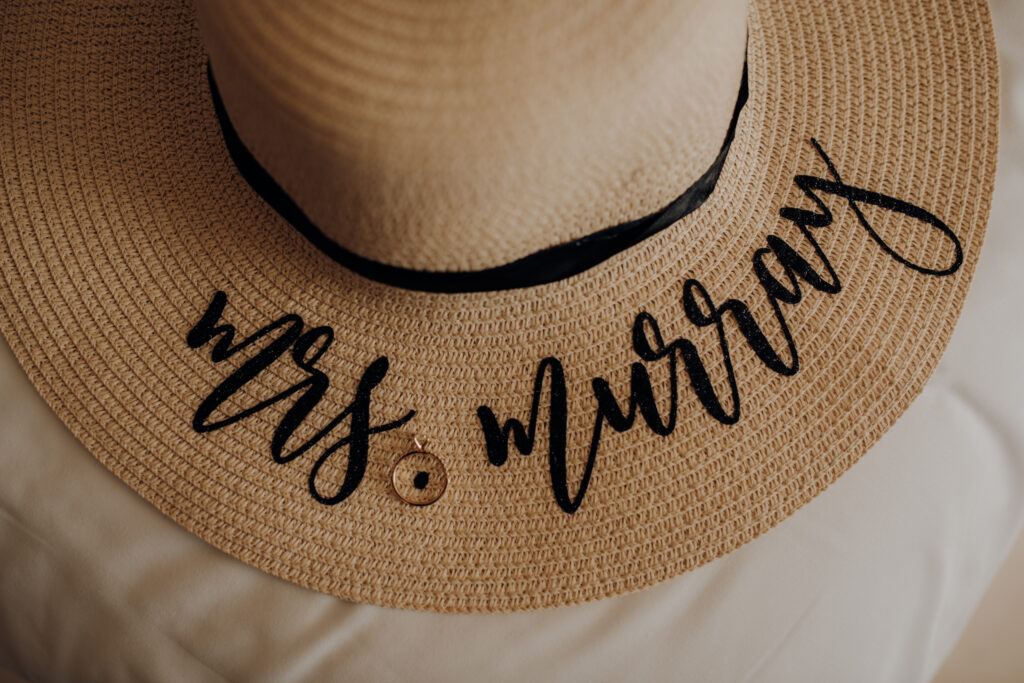 sun hat embroidered with "mrs. murray" with engagement ring 