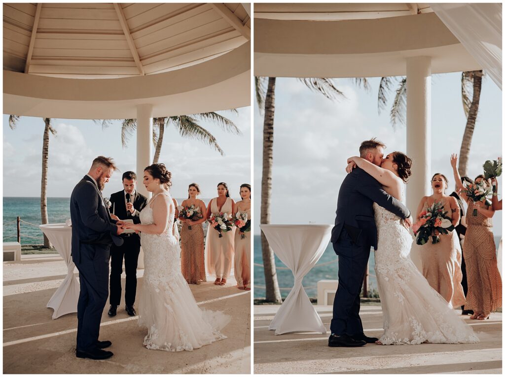 bride and groom first kiss under gazebo at hyatt ziva cancun with bridesmaids cheering in background 