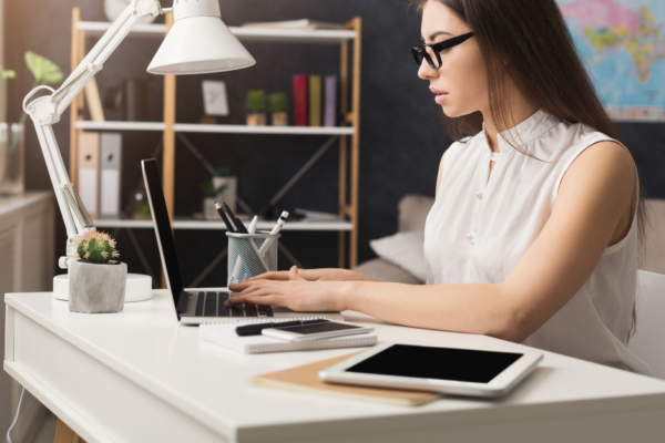 River cruise travel agent working at her desk to plan a customized river cruise itinerary for clients.