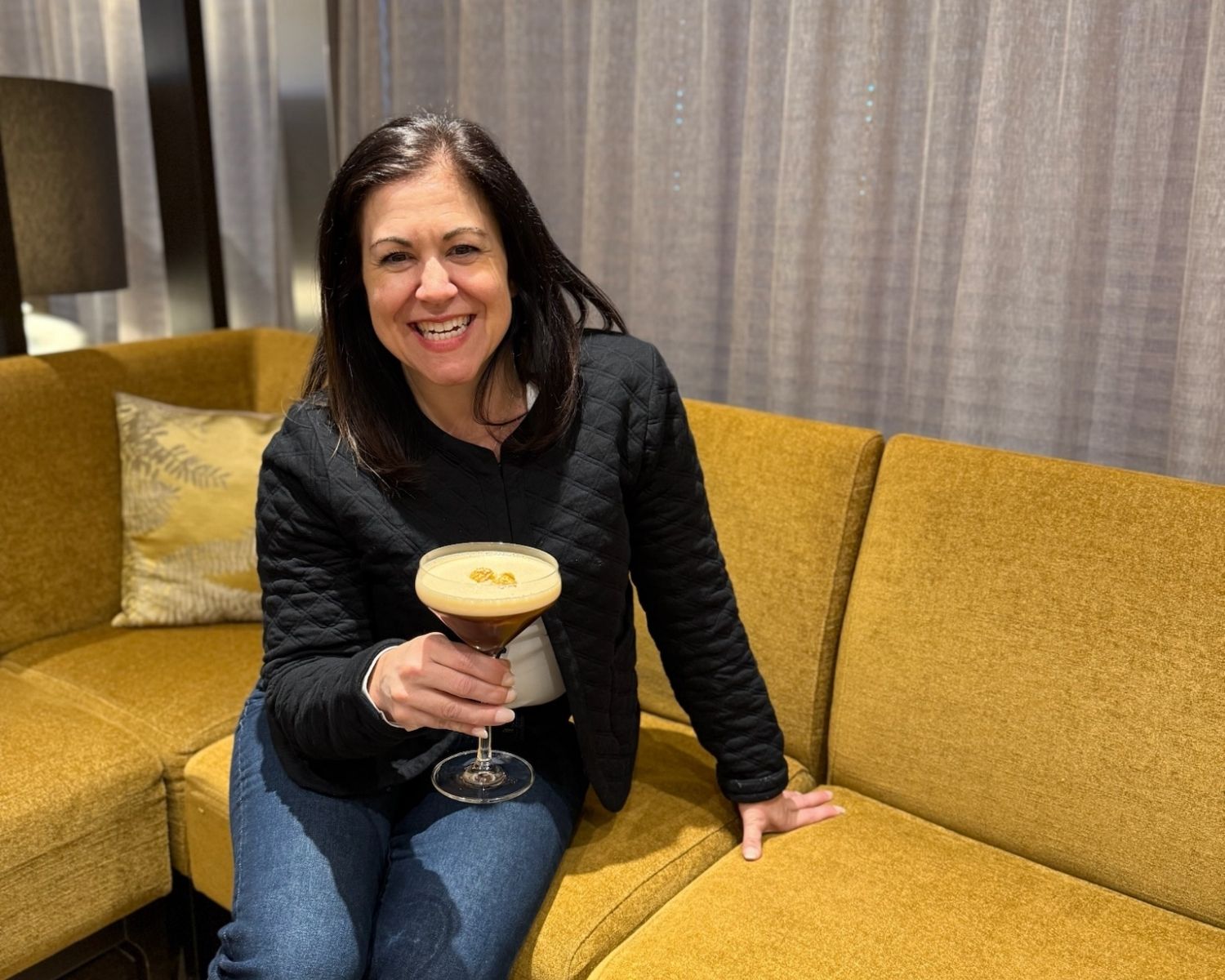 Travel advisor enjoying an espresso martini aboard an Avalon river cruise, showcasing the onboard experience offered by leading river cruise companies.