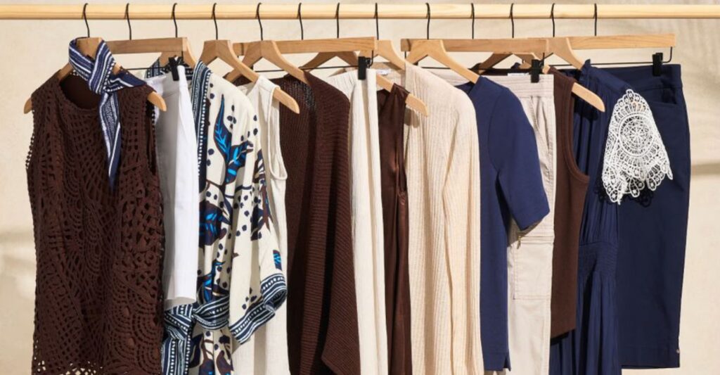 Neutral and coordinated clothing pieces in blues, creams, whites, and browns demonstrating a simple color palette for a river cruise packing list.